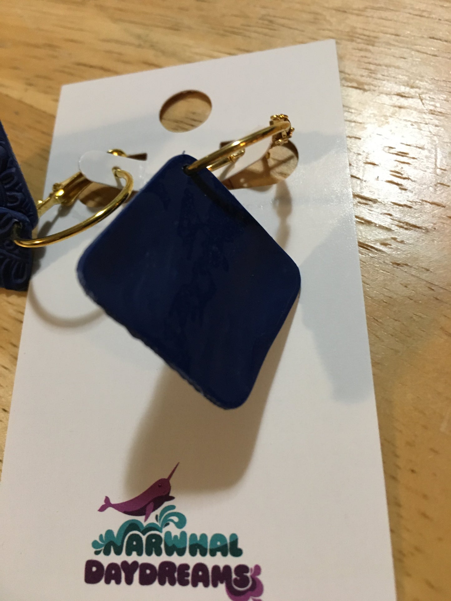 Textured navy squares on gold hoop earrings