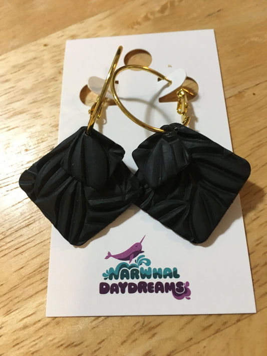 Textured dark gray squares on gold hoop earrings