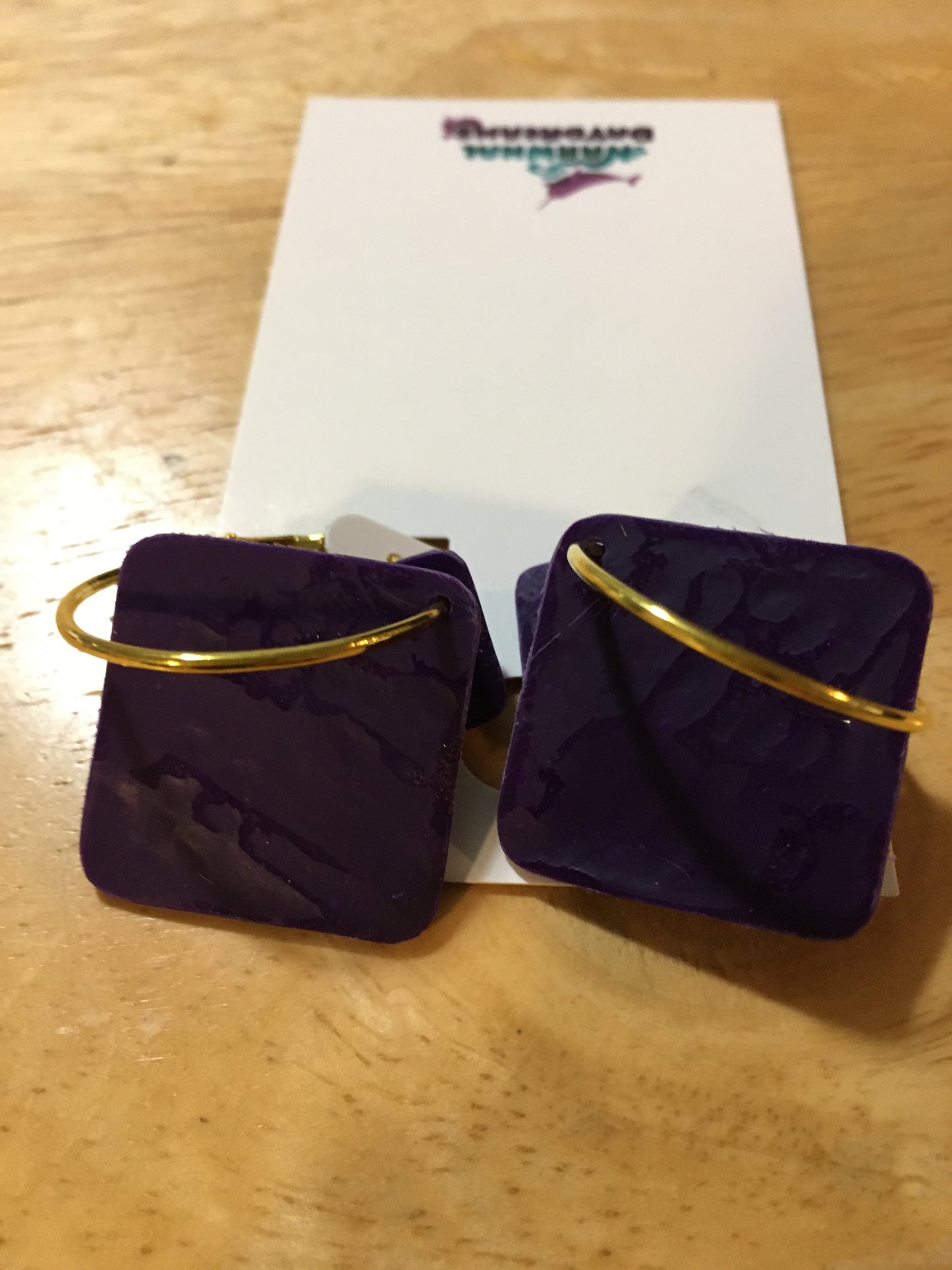 Textured dark purple squares on gold hoop earrings
