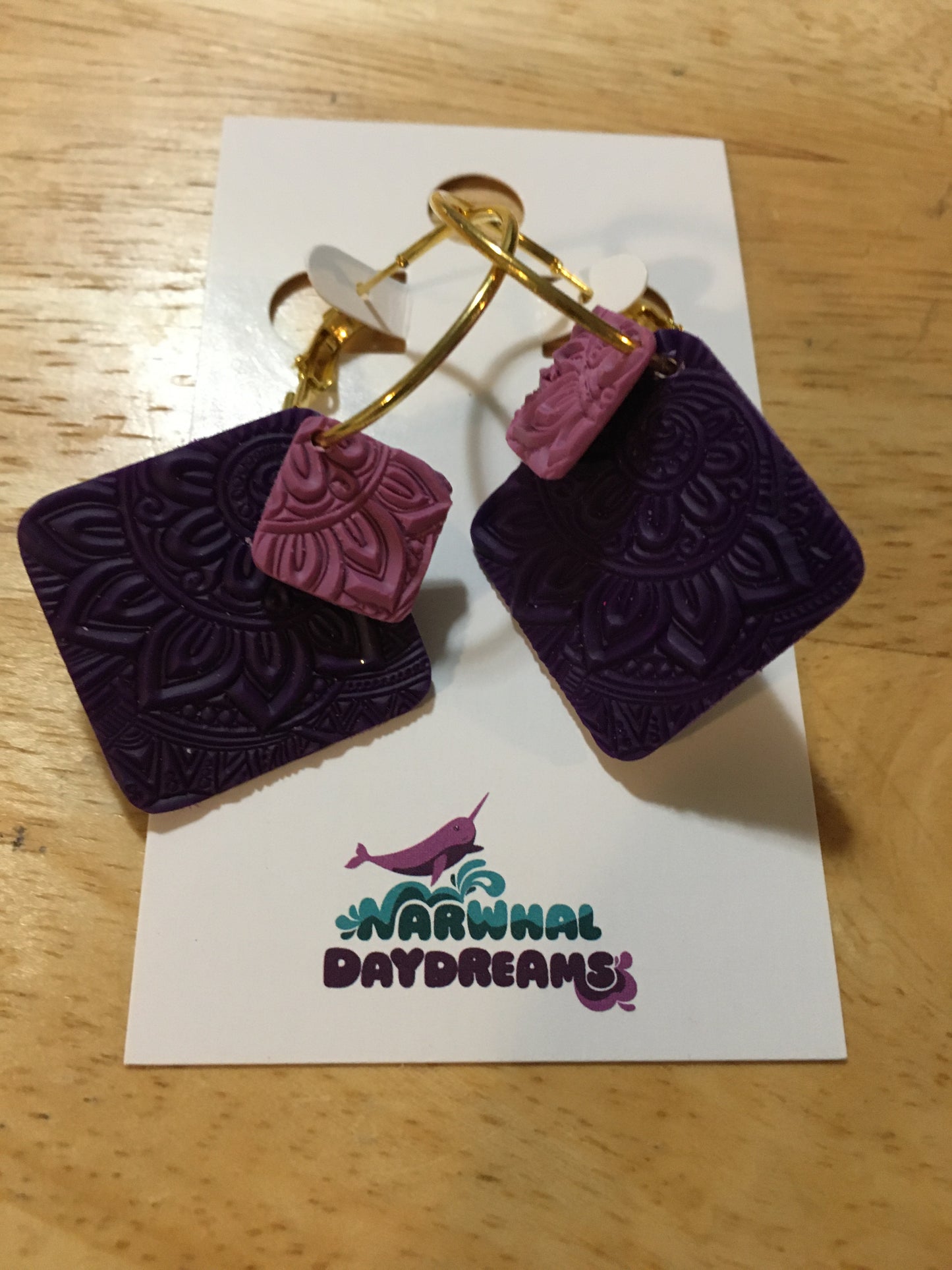 Textured dark purple and mauvey-purple squares on gold hoop earrings